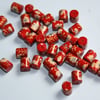 Red plastic decorated beads - 10pcs