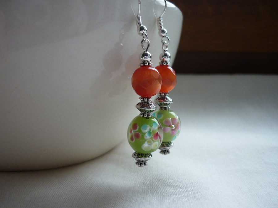 BURNT ORANGE, GREEN AND SILVER DANGLE EARRINGS.