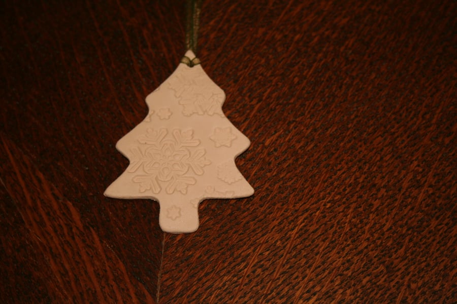 Handmade ceramic tree decoration impressed with snowflake design