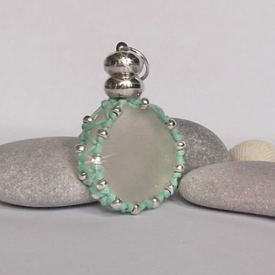 Sea glass pendant in a macrame beaded case. Sea glass jewellery