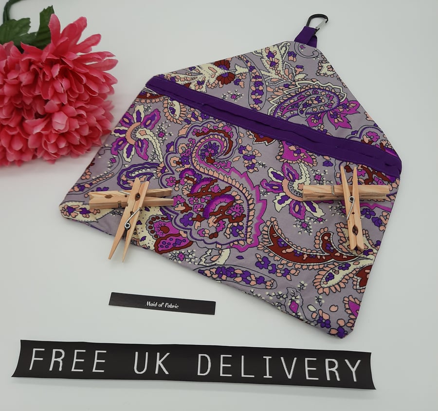 Peg bag in purple pattern fabric. 