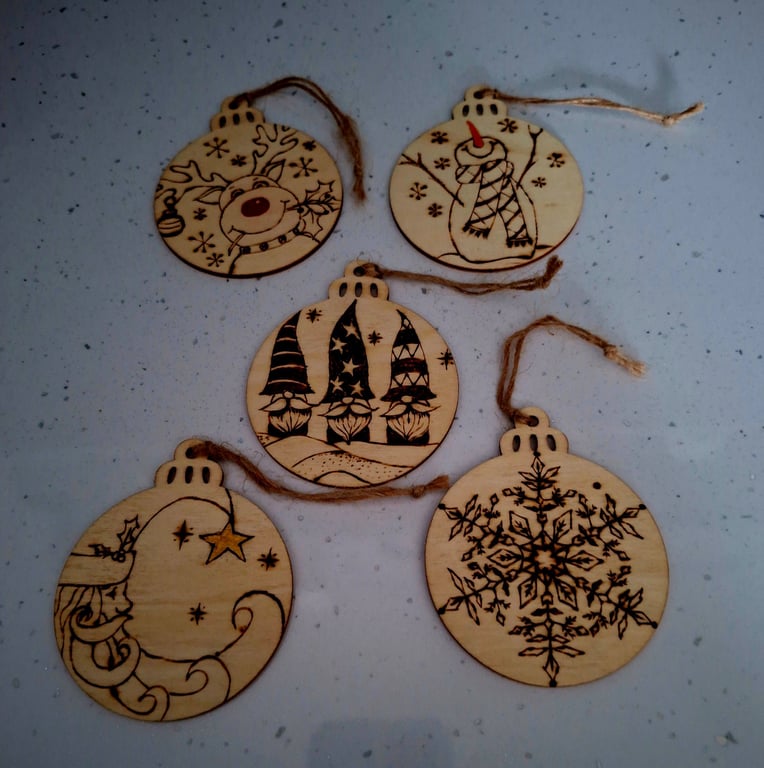 Pyrographed festive hanging bauble-shaped discs