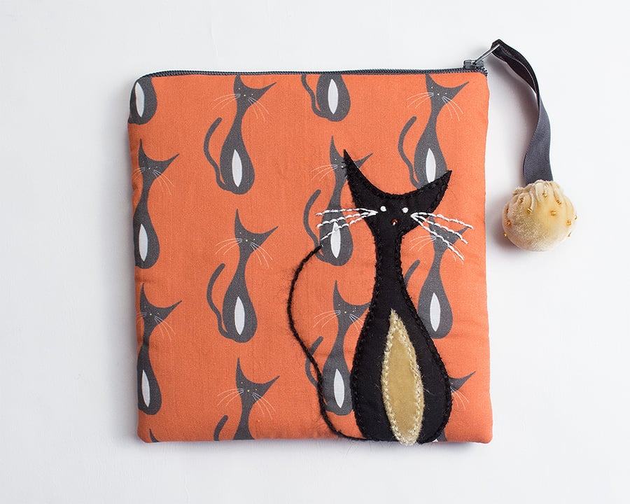 Orange and grey make up bag with mid century cat print and appliqué