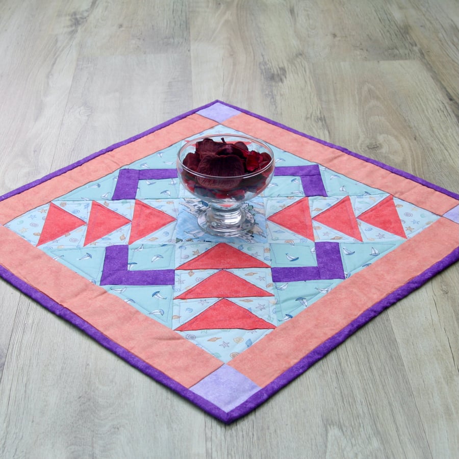 Handmade Quilted Seaside table topper with town scene and lighthouses.