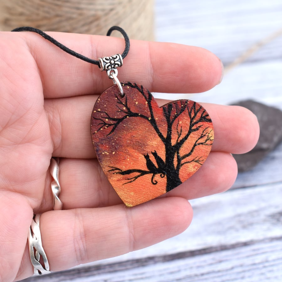Cats at sunset. Wooden heart pendant with tree silhouette.