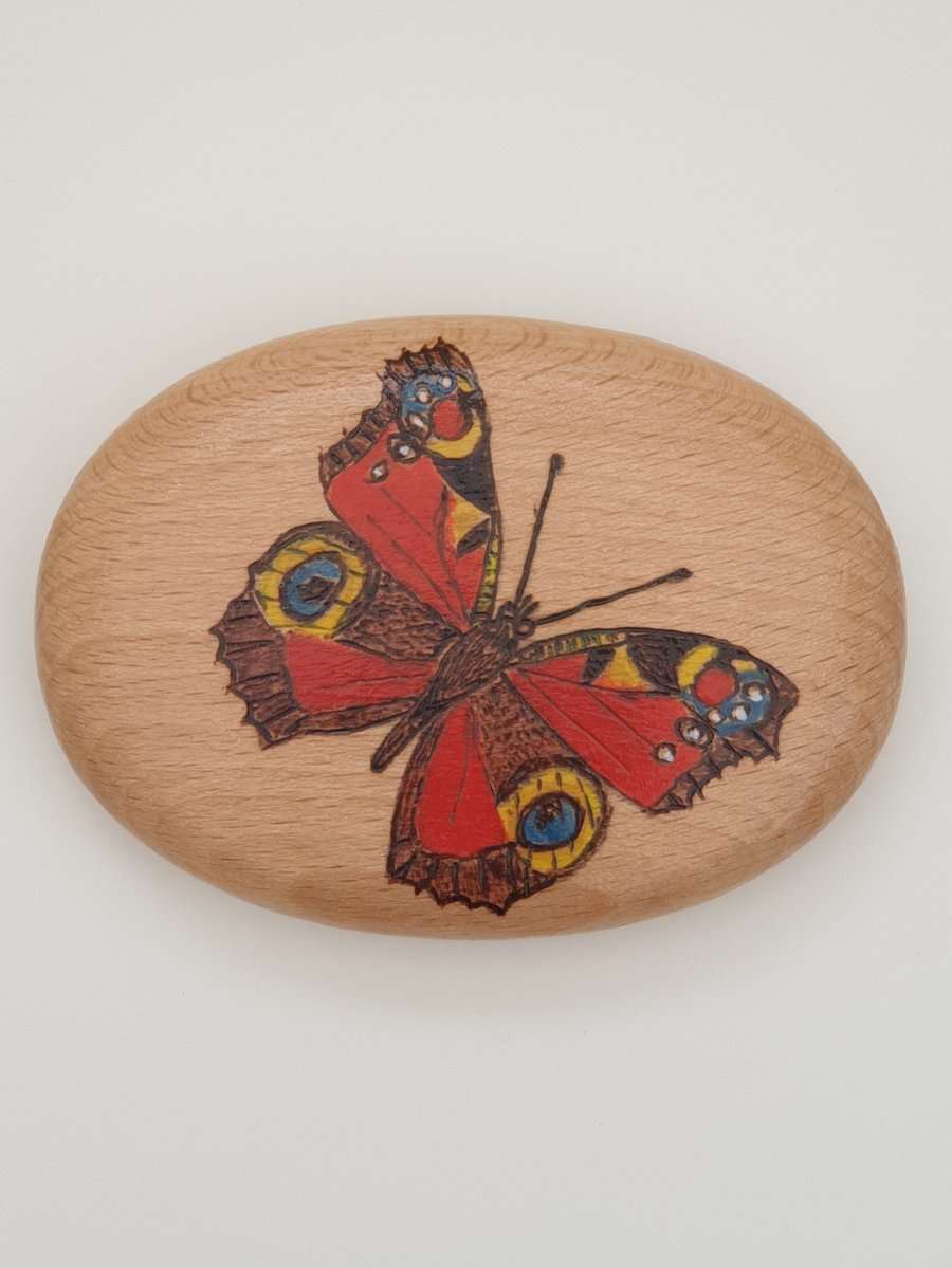 Pyrography peacock butterfly decorated wooden pebble, British wildlife gift