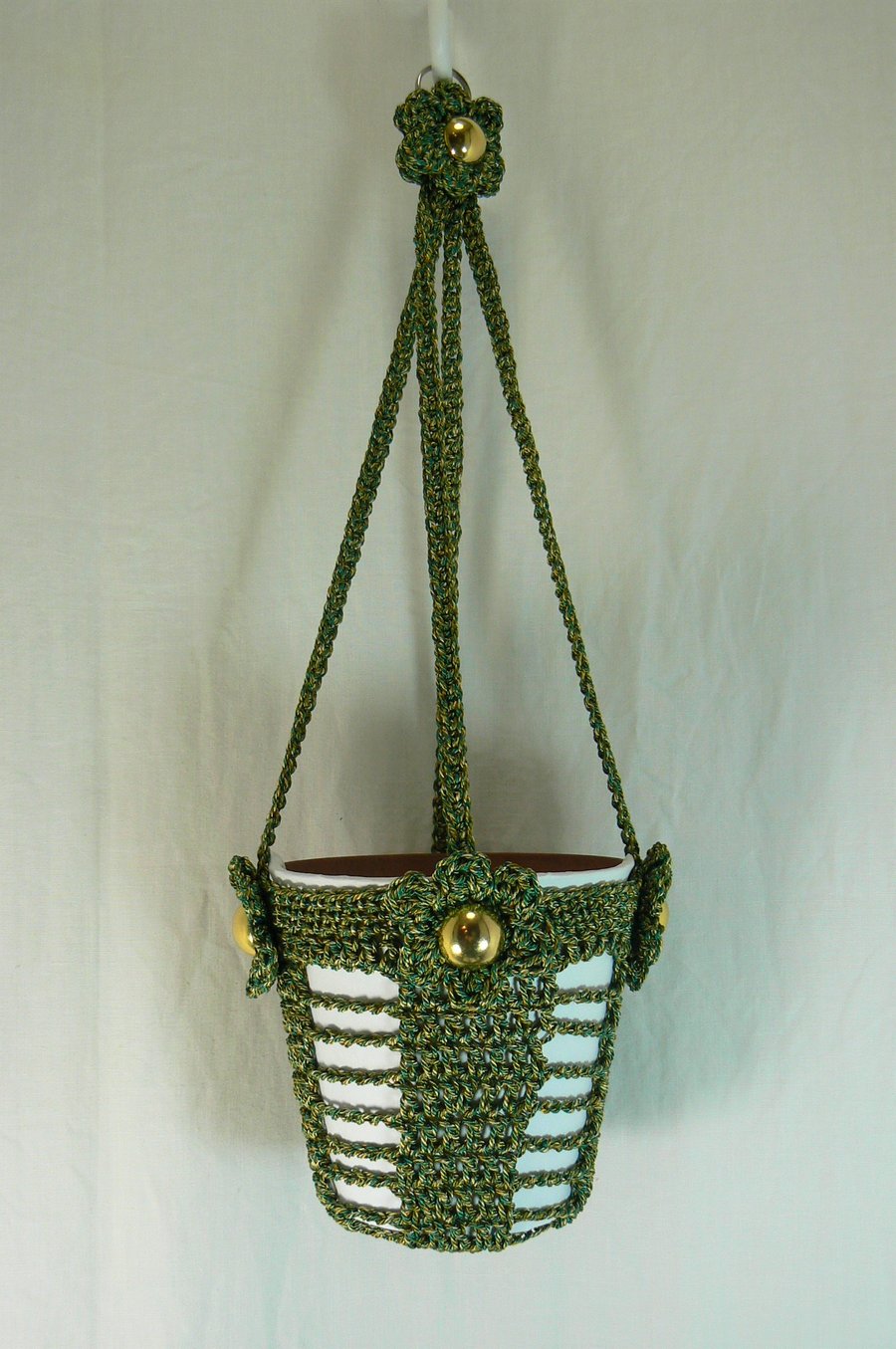 Crocheted hanging plant holder ( green and gold) with flower detail