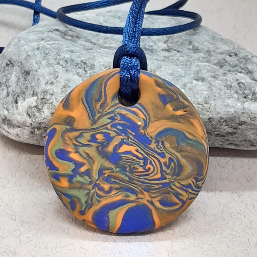 Orange and royal blue polymer clay pendant