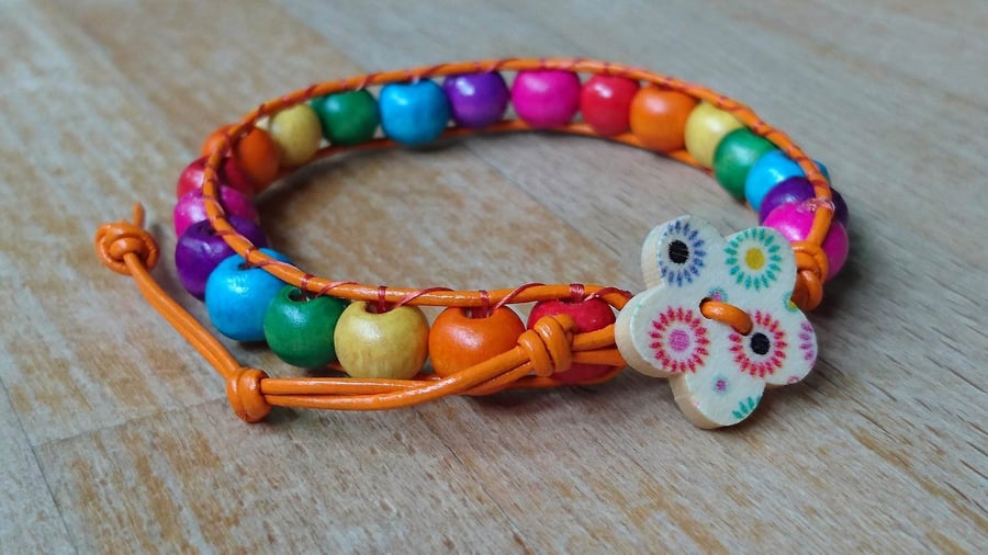 Rainbow coloured wooden bead and orange leather bracelet