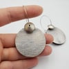 Silver coloured watery effect hooped dangly earrings