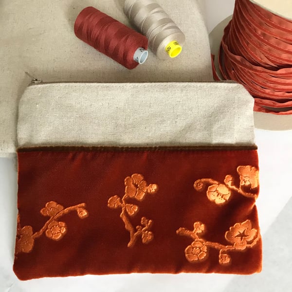 Orange zip pouch bag with floral embossed velvet & linen design, medium size.
