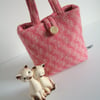 A little woollen bucket bag made from pink herringbone wool.