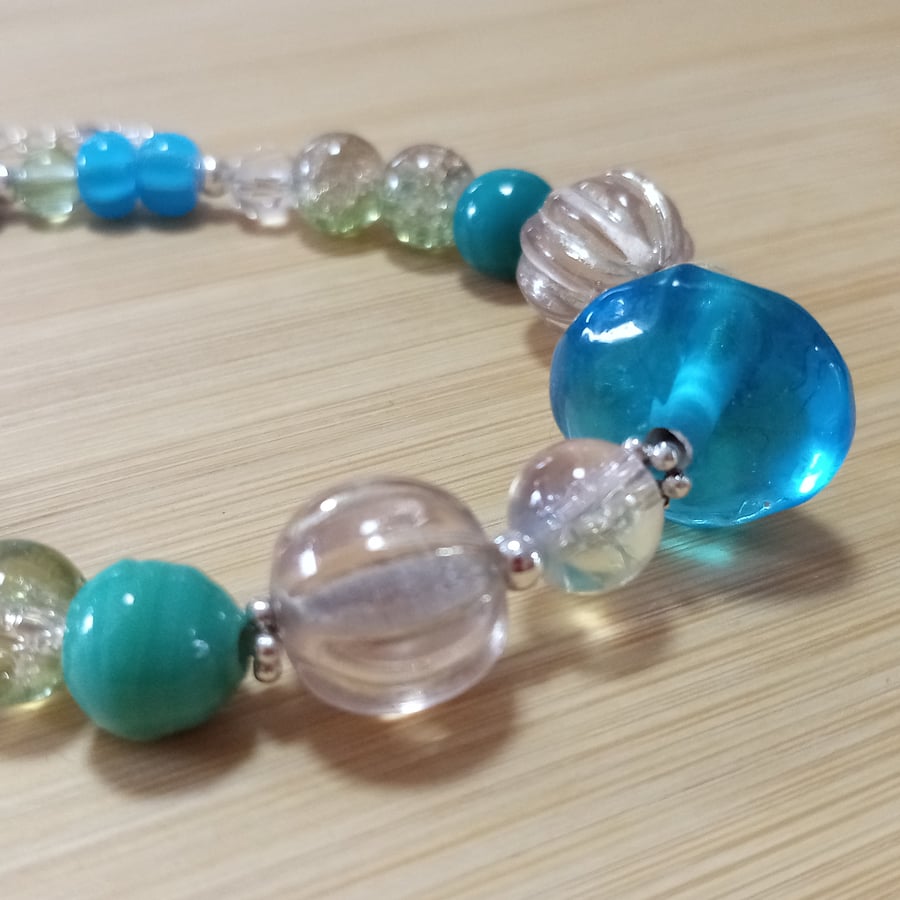 Blue, green and clear glass beaded bracelet