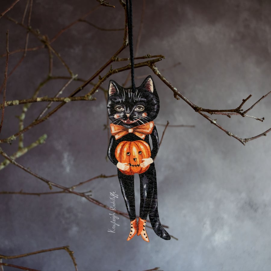Wooden Halloween decoration of Noir the black cat with a pumpkin