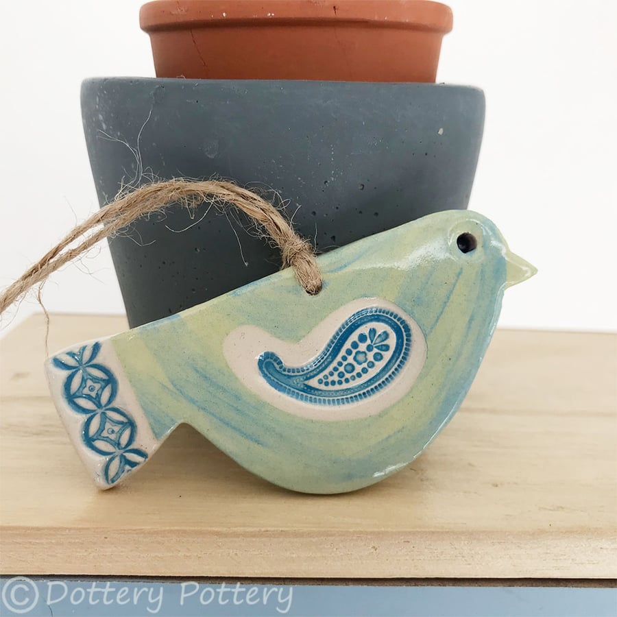 Ceramic bird decoration with patterned wing and tail 