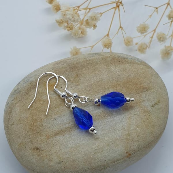 Beautiful silver plated earrings with a lovely royal blue glass teardrop faceted
