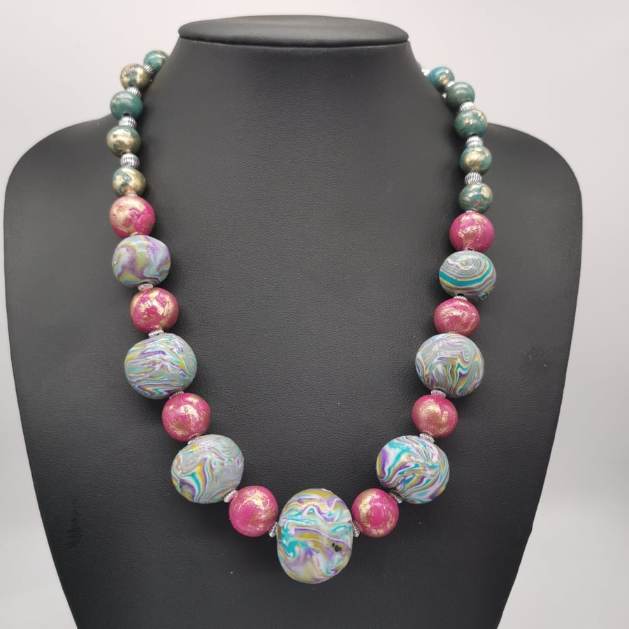 Statement, handmade, bead necklace with multicoloured, marbled focal beads.