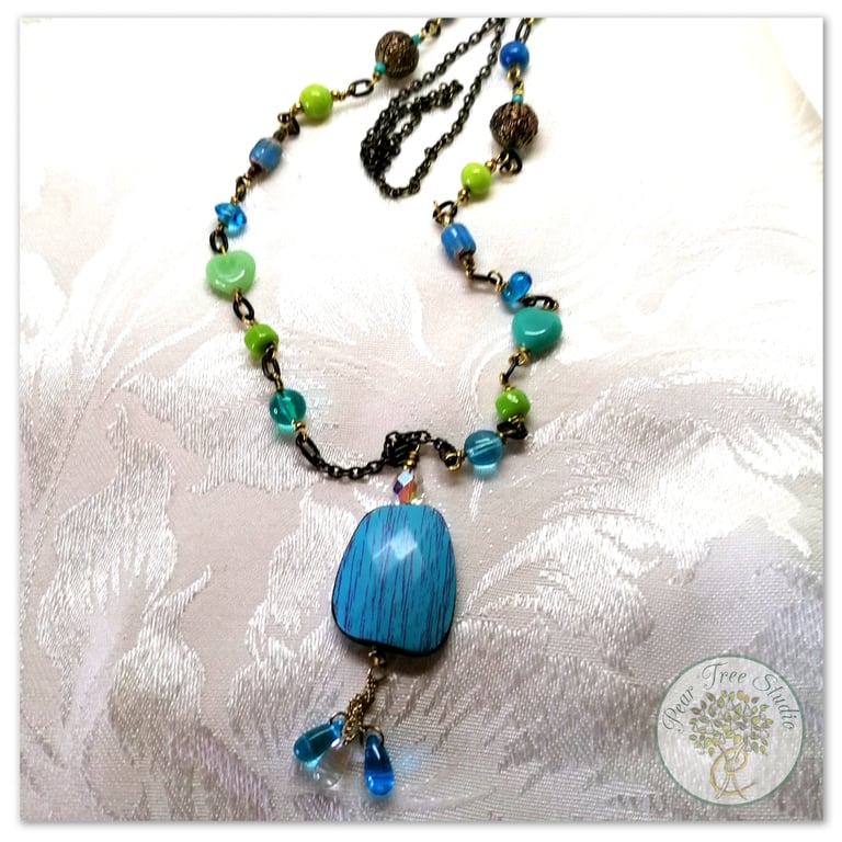 Handmade Long mixed blue and green bead necklace on antique bronze chain.