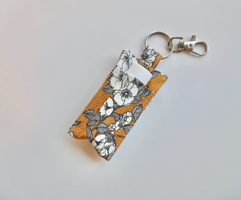 Key ring lip balm holder in mustard and black floral fabric keyring 