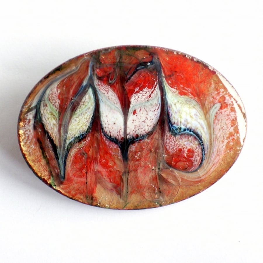 large oval brooch - scrolled white and dark blue over red on clear enamel