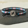 Trans flag coloured beads and black leather bracelet with star button