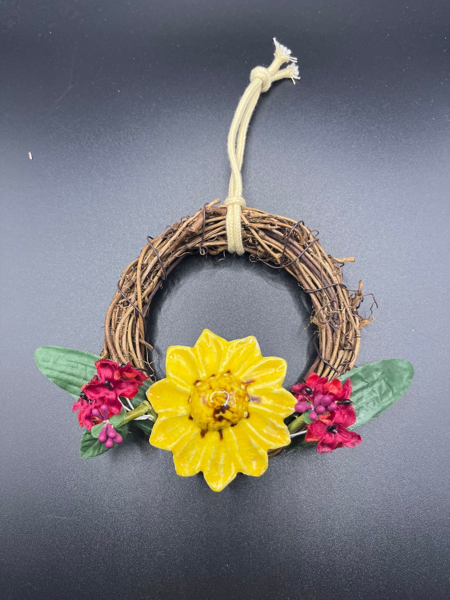 Wreath with a ceramic yellow flower 