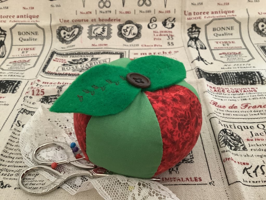 Cushion Sweet apple pincushion.  Red and green segments with vintage buttons.   