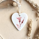 Handmade ceramic wildflower pendant in porcelain clay on waxed cotton cord