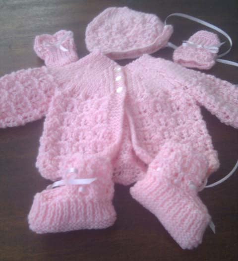 Pink knitted baby outfit