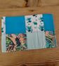 Cushion cover made in a green and blue theme with envelope closure.