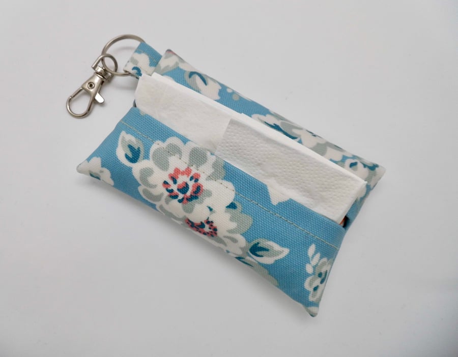 Tissue holder key ring for tissues or face mask in blue floral oil cloth fabric.