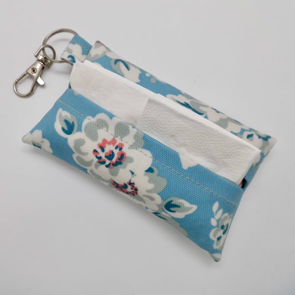 Tissue holder key ring for tissues or face mask in blue floral oil cloth fabric.