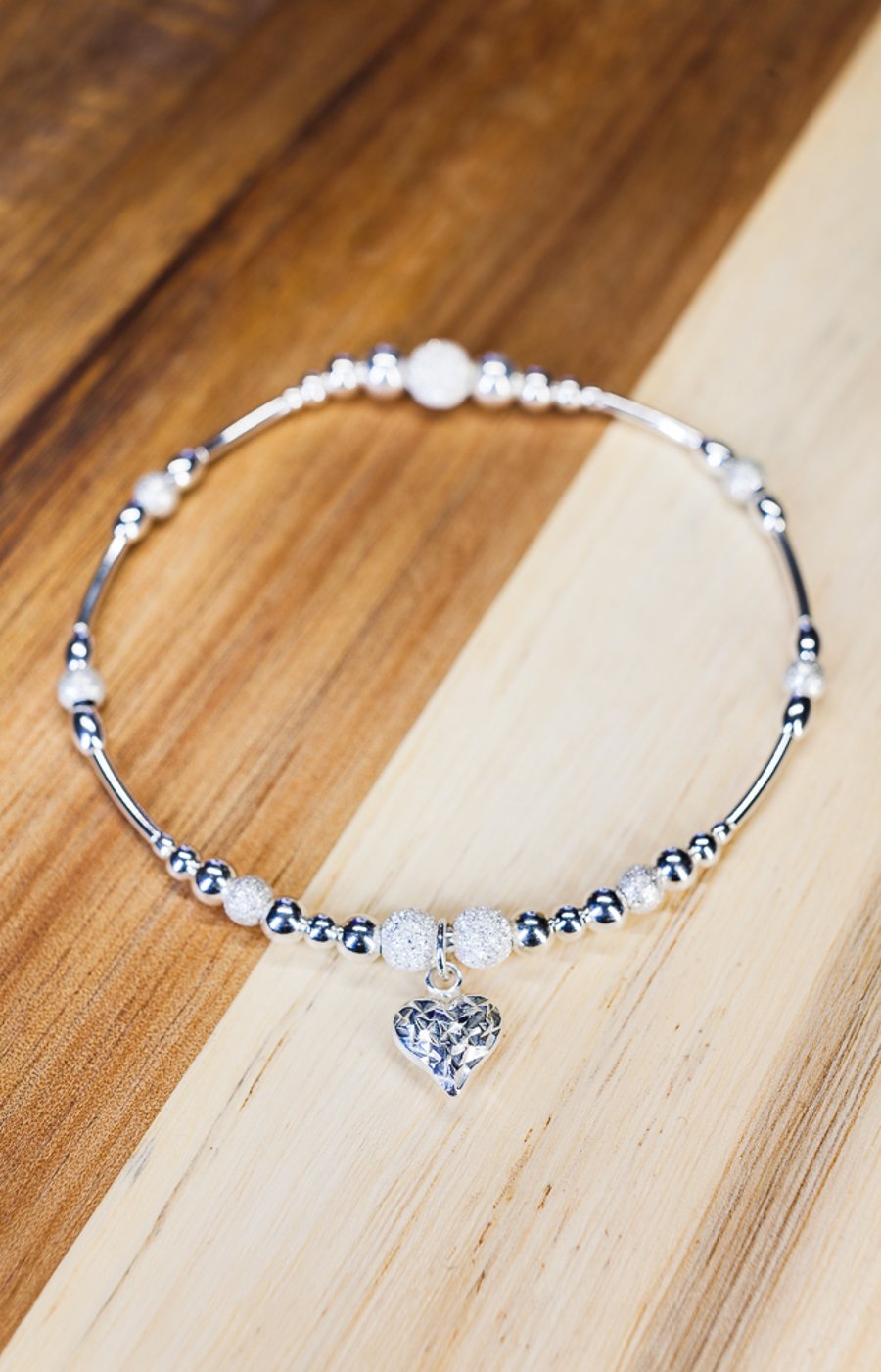 Sterling silver stretch charm bracelet with diamond cut heart 