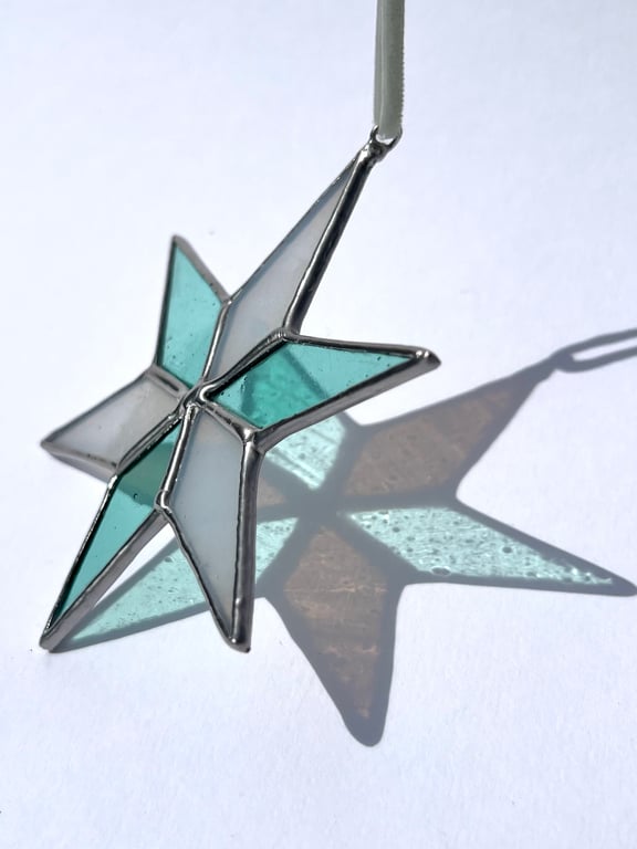 Pastel hued white and pale blue green stained glass Christmas star decoration