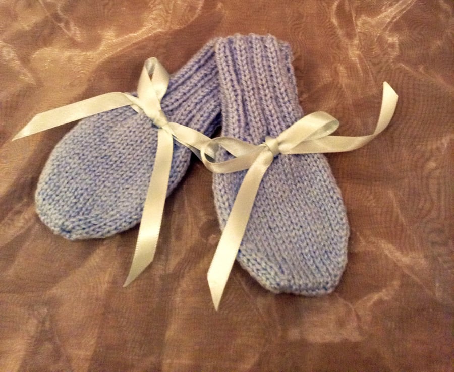 Little blue knitted baby mittens