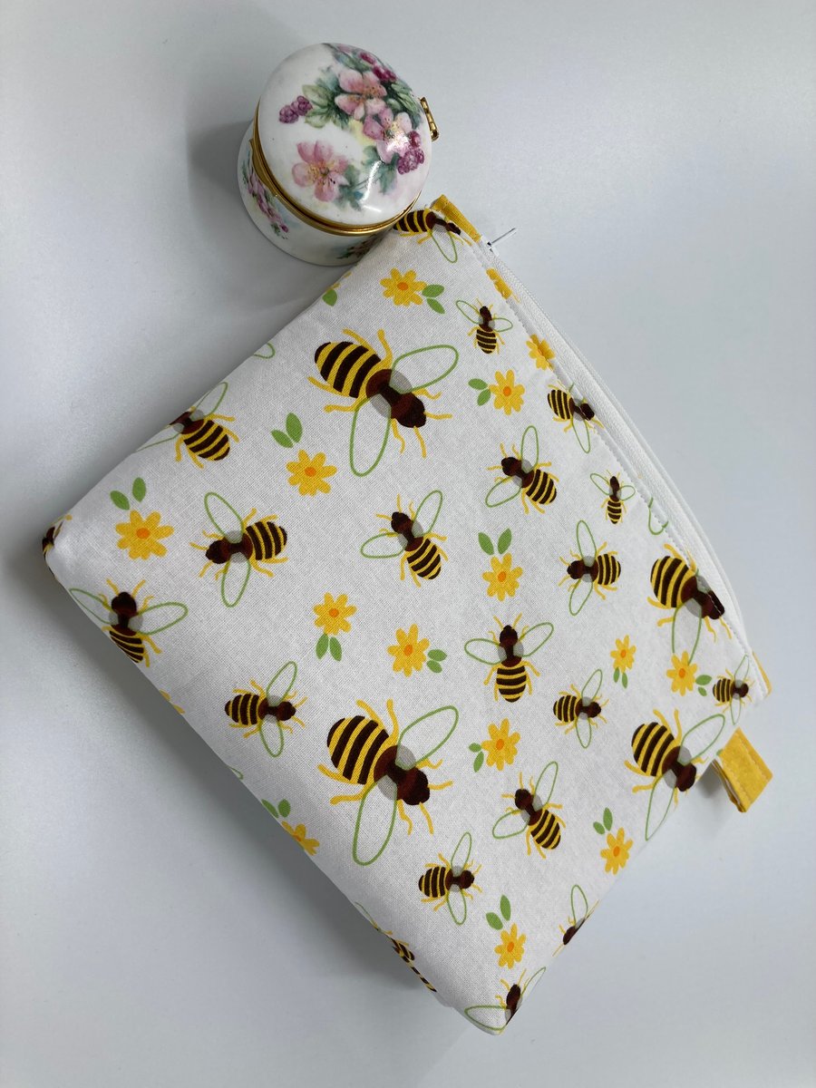 Bees cosmetic or small item storage purse with zip closure.