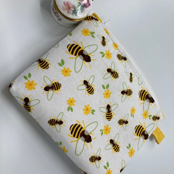 Bees cosmetic or small item storage purse with zip closure.