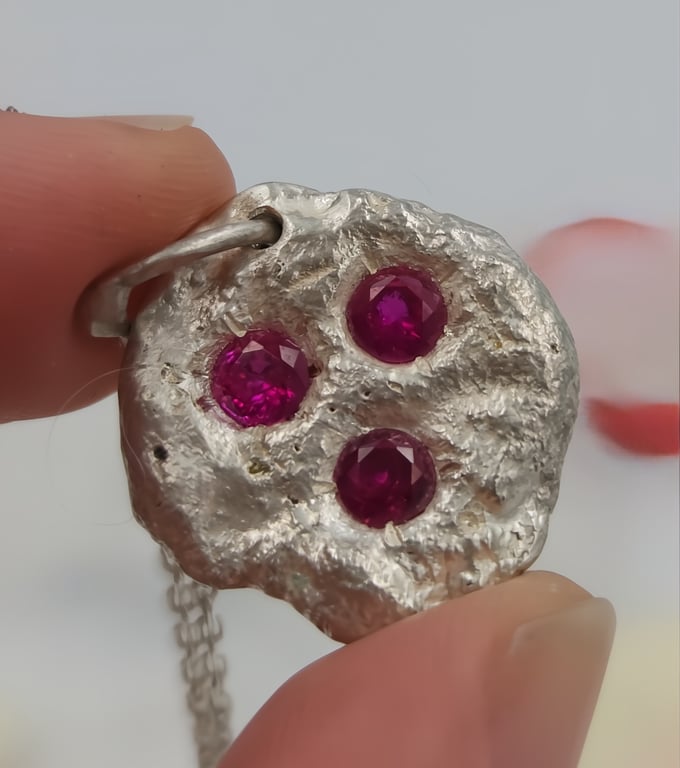 Molten Elegance: Sterling Silver Pendant with Synthetic Rubies
