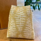 Cotton fabric doorstop in mustard with cream fern print, filled with pebbles