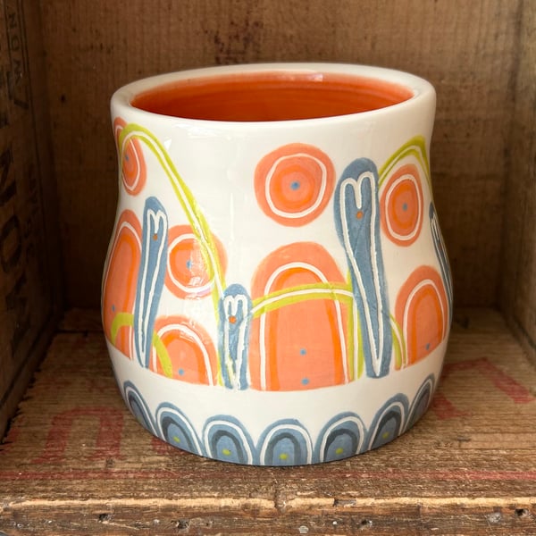 Ceramic hand thrown pot with unique orange and blue decoration