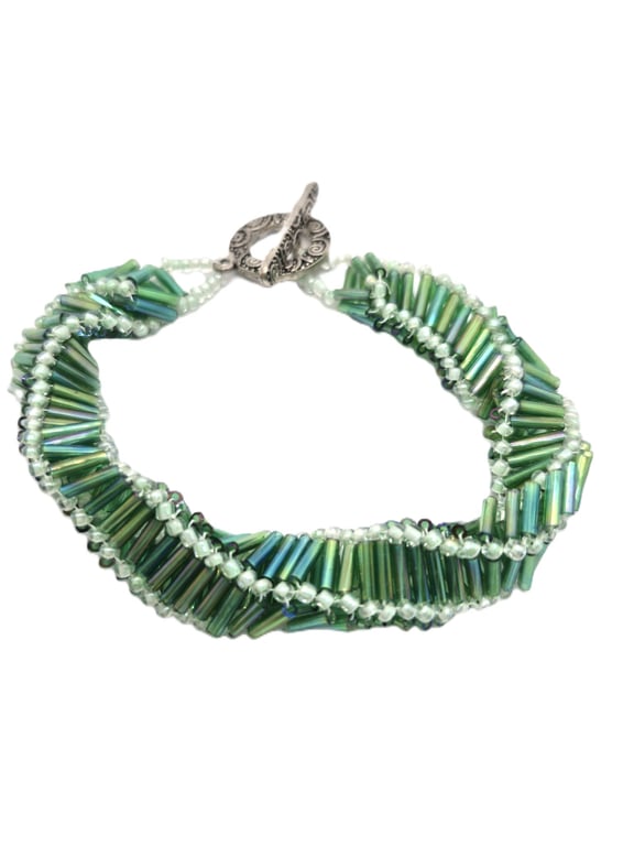 Handmade spiral beaded bracelet in green coloured bugle beads