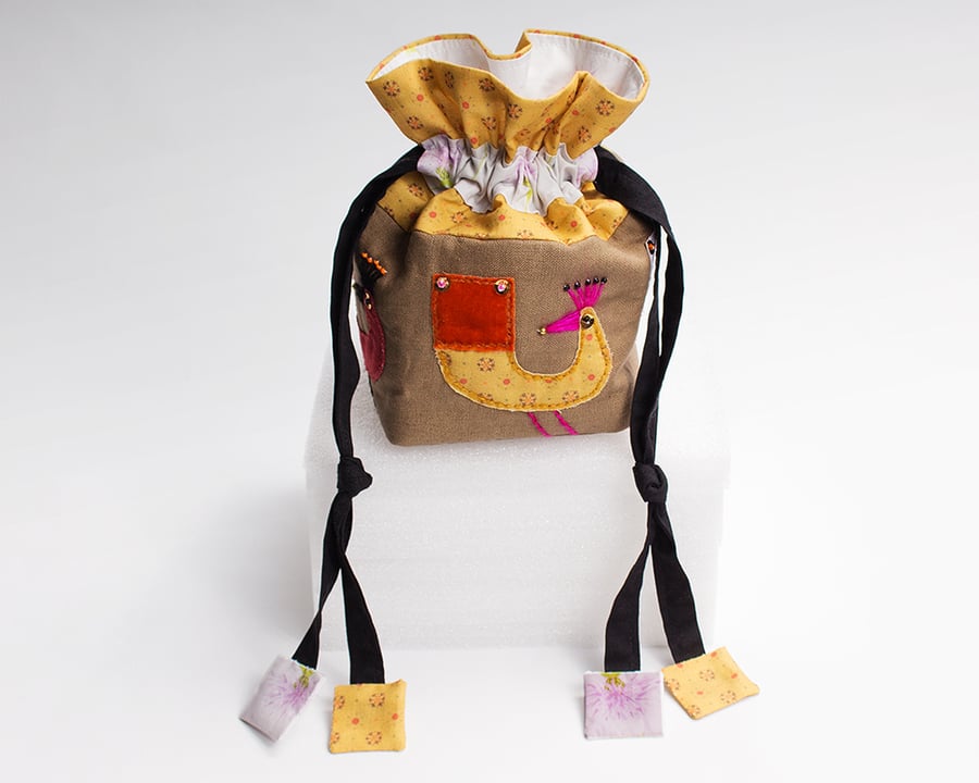 Brown and red drawstring bag with hand appliquéd birds