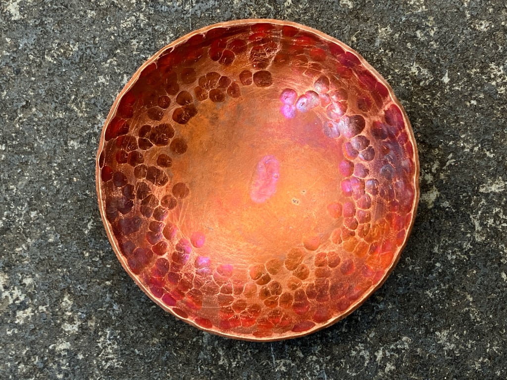 Flame painted copper bowl with hammered detail.