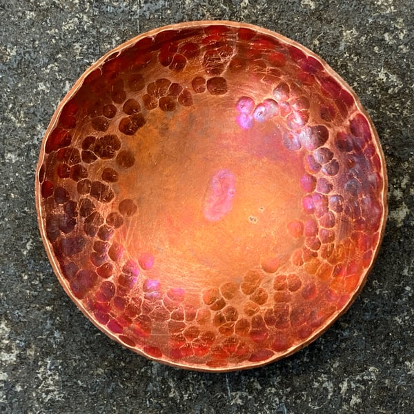 Flame painted copper bowl with hammered detail.