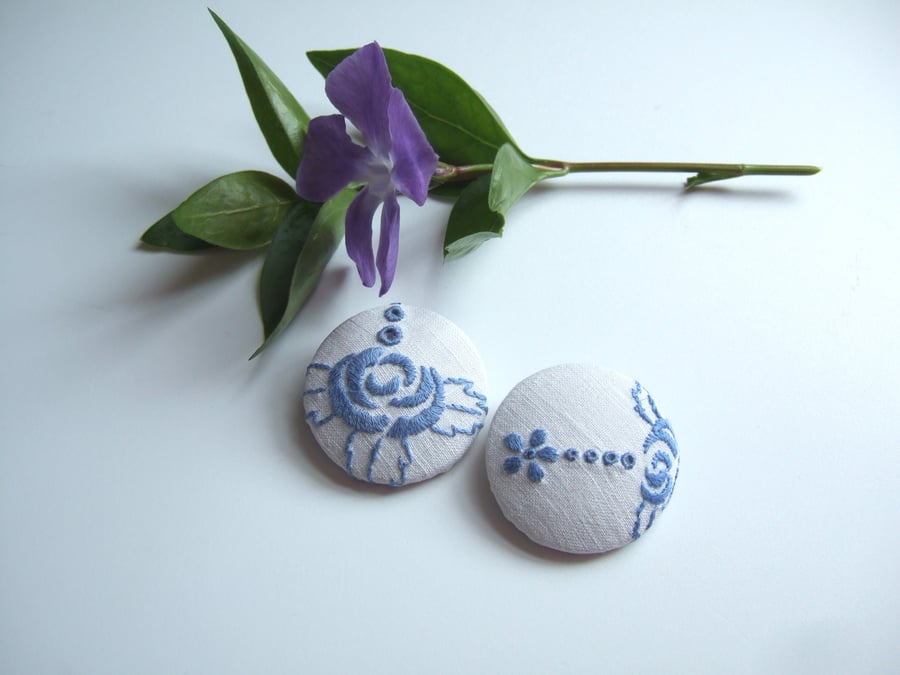 A pair of extra large vintage embroidery covered buttons. 