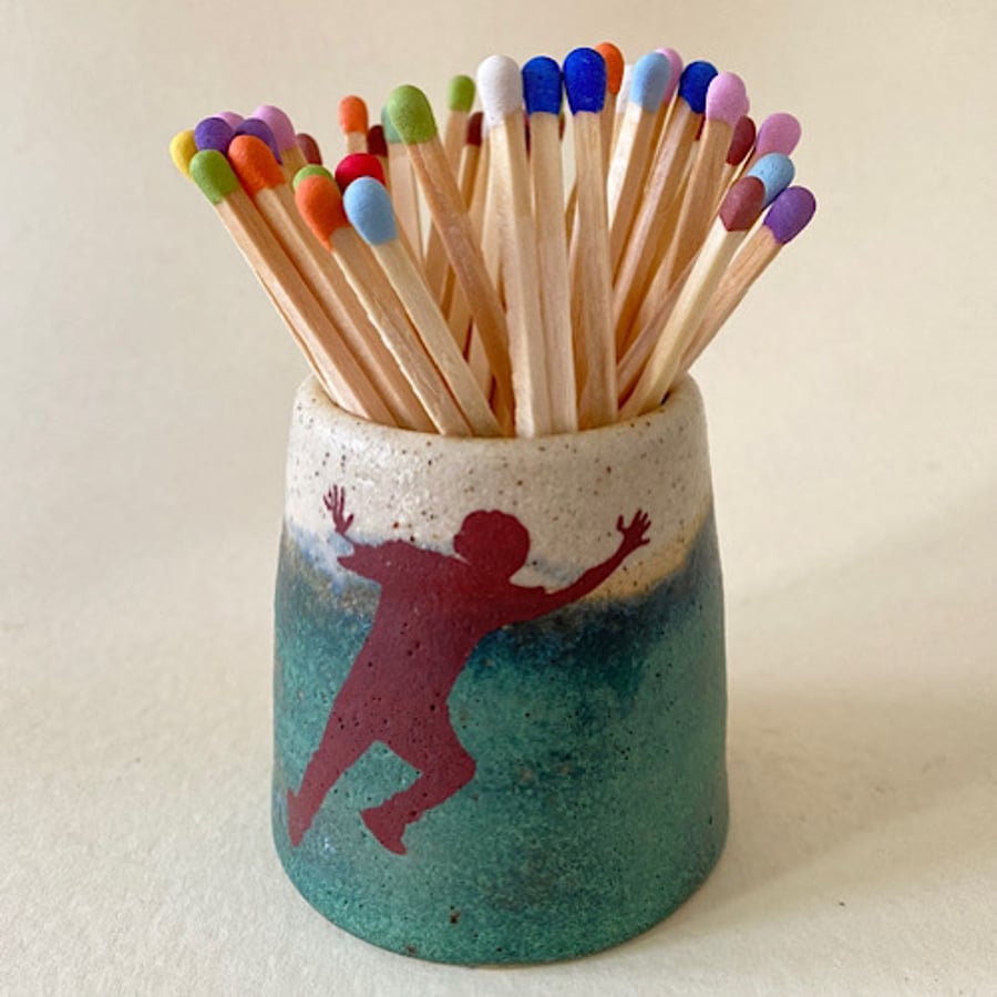 Strike a pose. Ceramic striker pot.