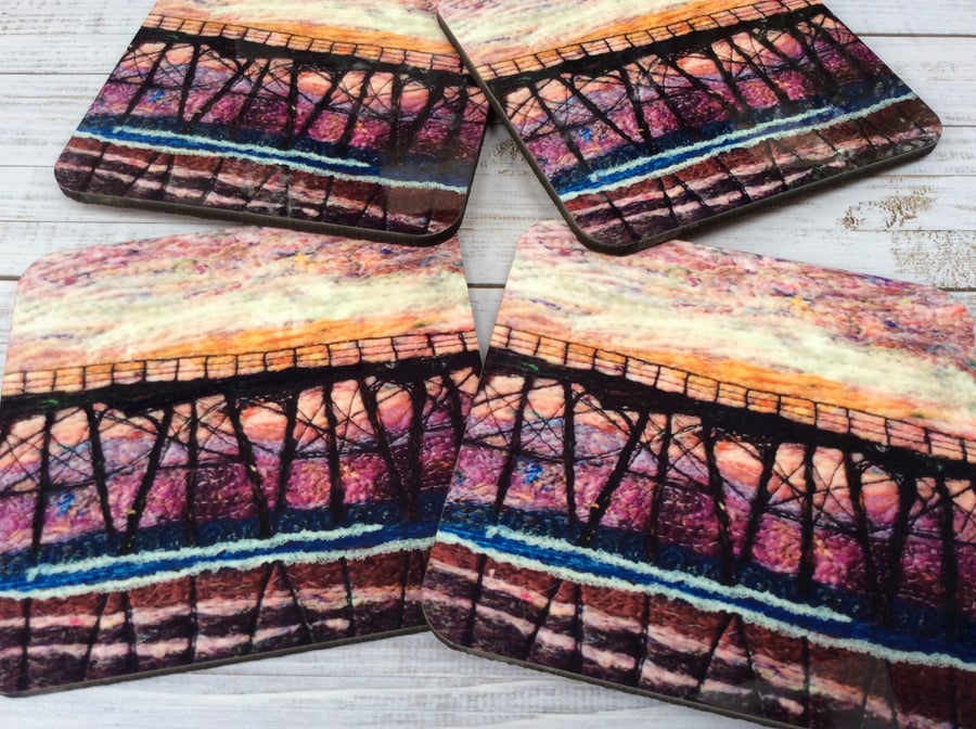 Sunset seascape coaster with pier.