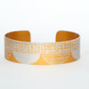 Seed head pattern aluminium cuff orange