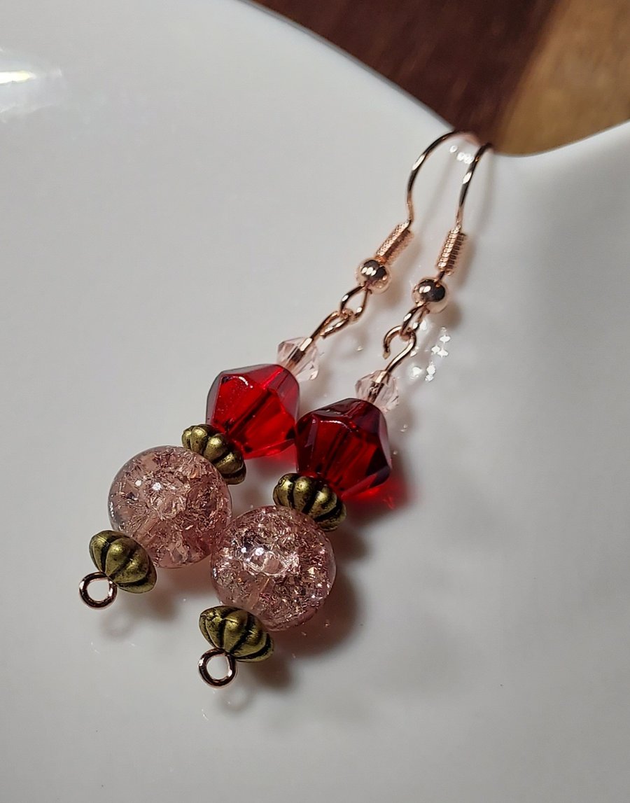Hypoallergenic beaded earrings in pink and red. 
