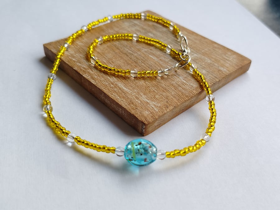 Yellow Seed Bead Single Strand Necklace with Blue Speckled Bead